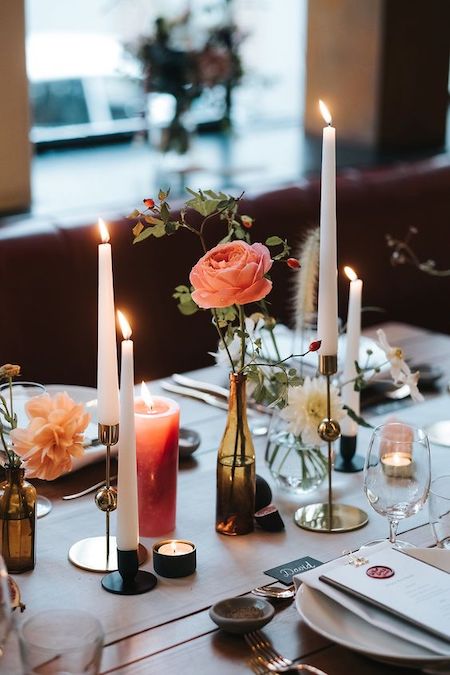 table setting featuring flowers and candles